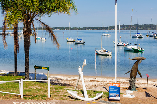 Soldiers Point, NSW, Australia - March 15, 2018: Sailing boats on anchor at Sunset Beach