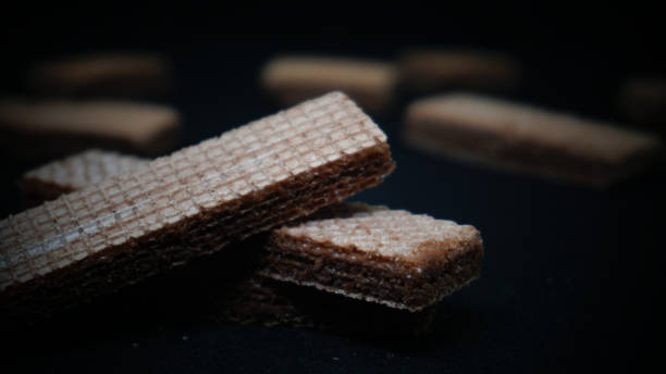 istock Sweet wafers on black background 1411323835