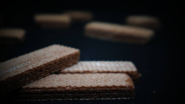 istock Sweet wafers on black background 1411323841