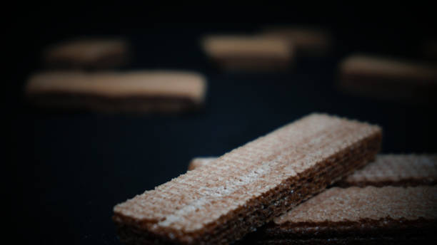 istock Sweet wafers on black background 1411323871