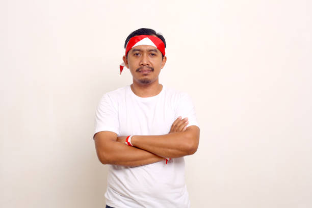 istock Calm asian man standing with folded hand. Indonesian independence day concept. Isolated on white 1411326556