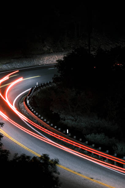 istock Car Tail-lights on dark road 1411328175