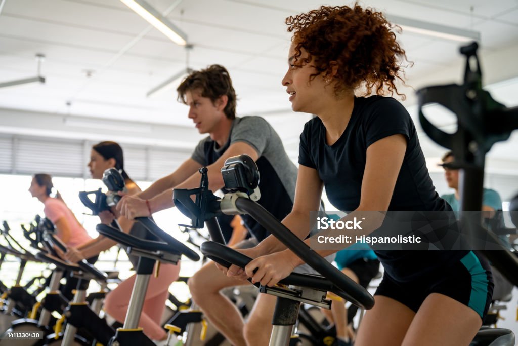 Group of fit people working out in a exercising class Group of fit people working out in a exercising class - fitness concepts Gym Stock Photo