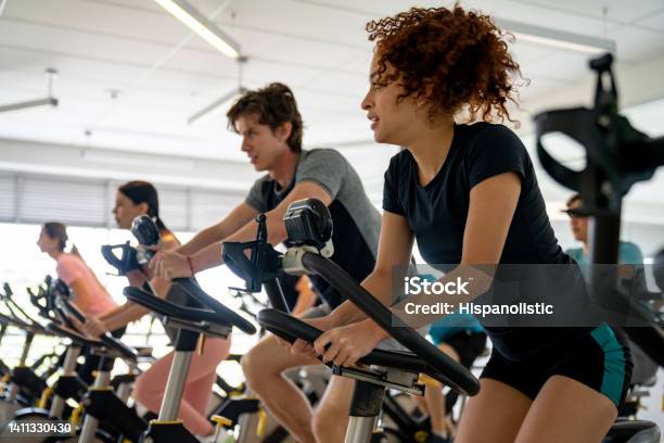 Group Of Fit People Working Out In A Exercising Class Stock Photo - Download Image Now