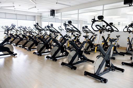 Group of bicycles in an empty exercising classroom at the gym - sports equipment concepts