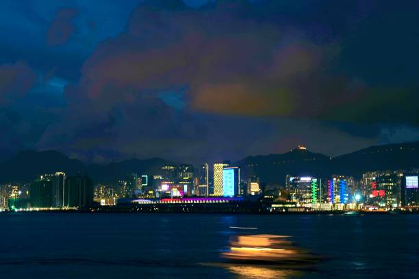 istock Evening Victoria Harbour with motion blur speed boat 1411330595