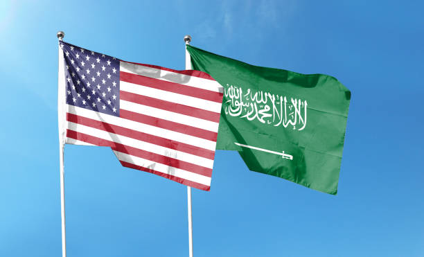 istock Twin Flags USA and Saudi Arabia Waving Flags with Textured Background 1411331759