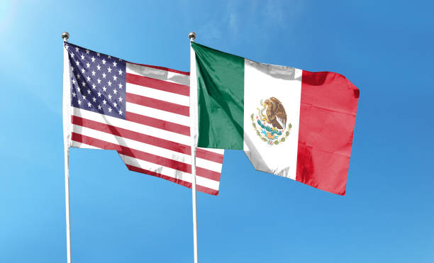 istock Twin Flags USA and Mexico Waving Flags with Textured Background 1411331853