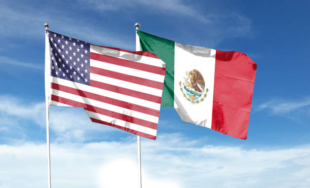 istock Twin Flags USA and Mexico Waving Flags with Textured Background 1411331879
