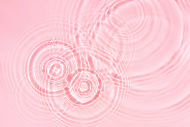 istock Abstract cosmetic background, pink water texture with round ripples, close up 1411333276