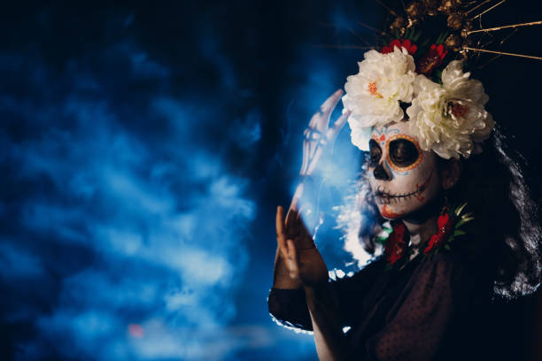 Woman with mexican skull halloween makeup on her face. Day of the dead and halloween Woman with mexican skull halloween makeup on face. Day of the dead aka Dia de los Muertos and halloween concept. muerte stock pictures, royalty-free photos & images