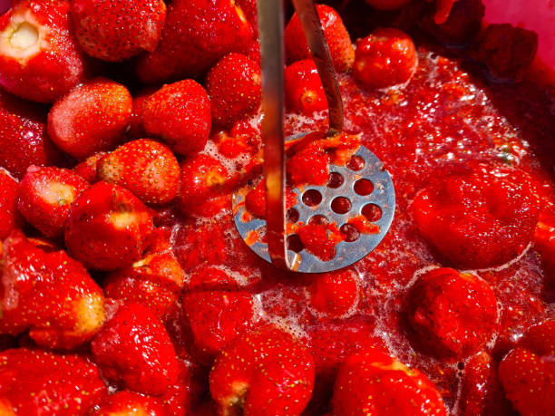 Closeup of crushed strawberries with puree. Making strawberry jam Closeup of crushed strawberries with puree. Making strawberry jam concept strawberry crush stock pictures, royalty-free photos & images