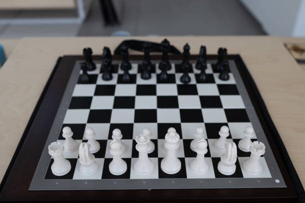 istock New chess board with chess pieces on table for game 1411337010