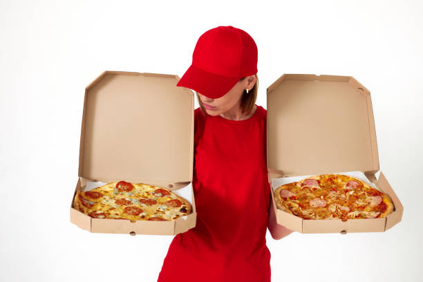 istock pizza delivery girl showing pizza inside boxes 1411337129