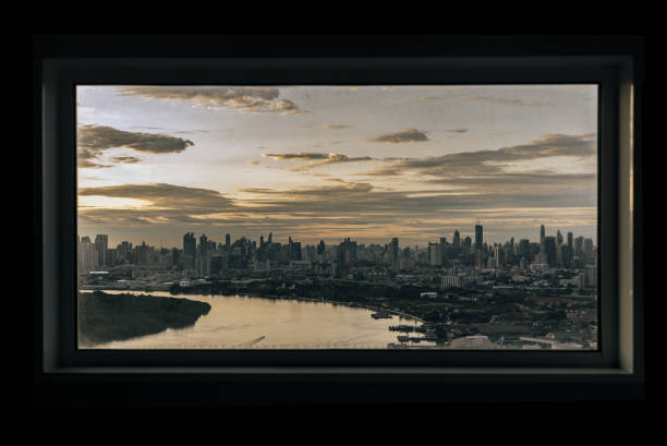 istock Skyscrapers along Chao phraya river in the evening time. Seen through a bedroom window frame. The beautiful view of Bangkok city, 1411337548