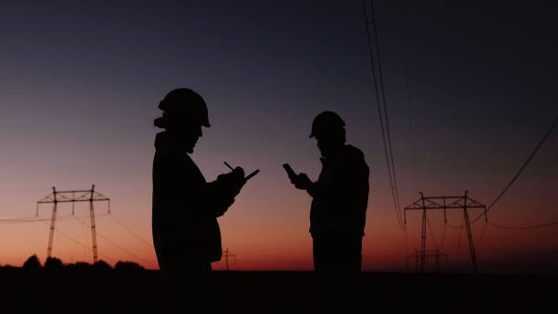 Electrical engineers working on Electrical Pylons Translation, discussing the condition of the Electrical Power Pole.