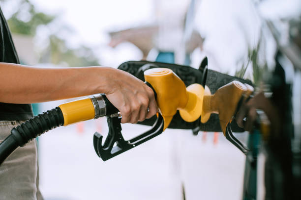 Woman refueling the car at the gas station stock photo