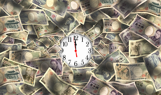 Japanese yen ills and clock face