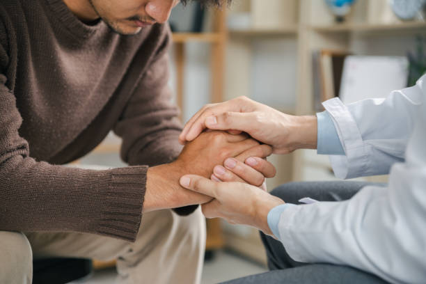Hands of medical personnel comforting to reassure the patient in clinic. stock photo