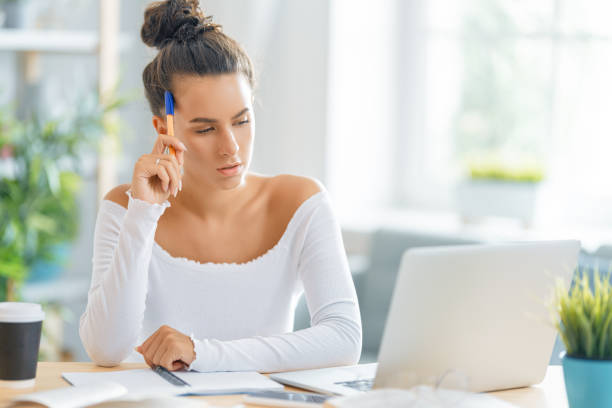 istock woman working on laptop at home 1411350098