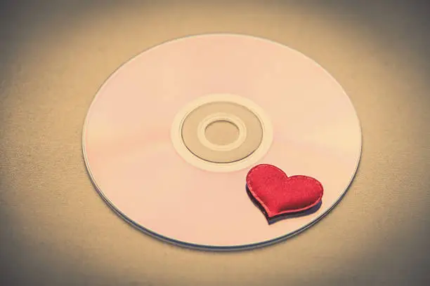 Toned Photo of CD Disk with a Red Heart closeup