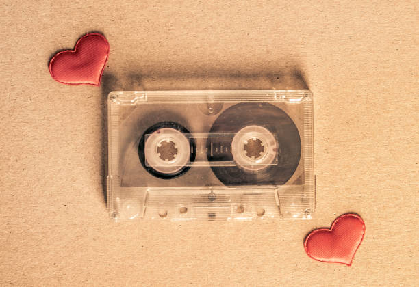 Audio Cassette with a Hearts Toned Photo of the Old Audio Tape Cassette with a Red Hearts on the Paper closeup mix tape heart stock pictures, royalty-free photos & images