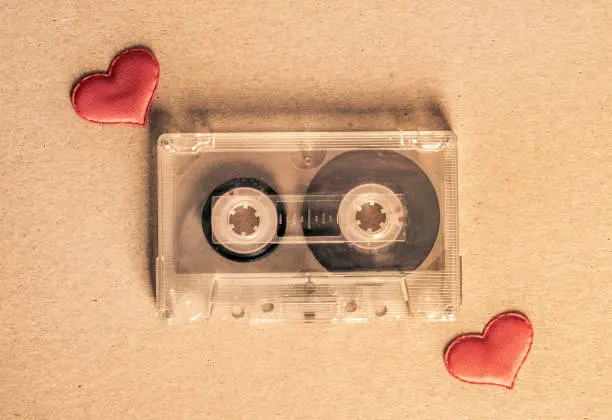 Toned Photo of the Old Audio Tape Cassette with a Red Hearts on the Paper closeup