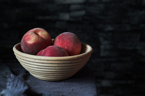 fresh peaches in rustic basket
