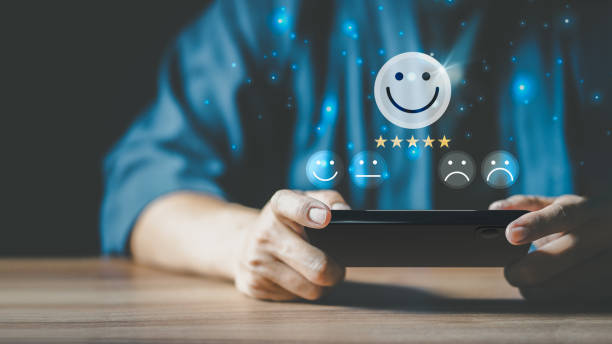 istock Man using a smartphone in give rating to service experience on application. Online customer review satisfaction feedback survey. 1411353105