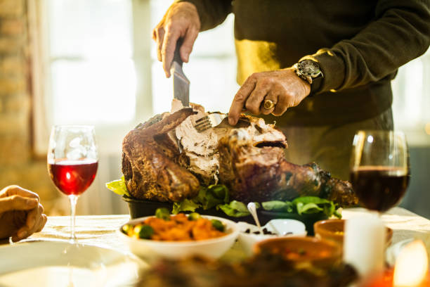 istock Unrecognizable man carving turkey meat on Thanksgiving. 1411354715