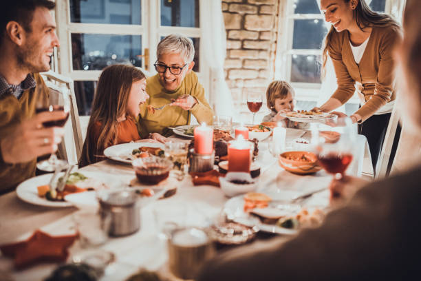 istock Happy multi-generation family enjoying during dinner at home. 1411355294
