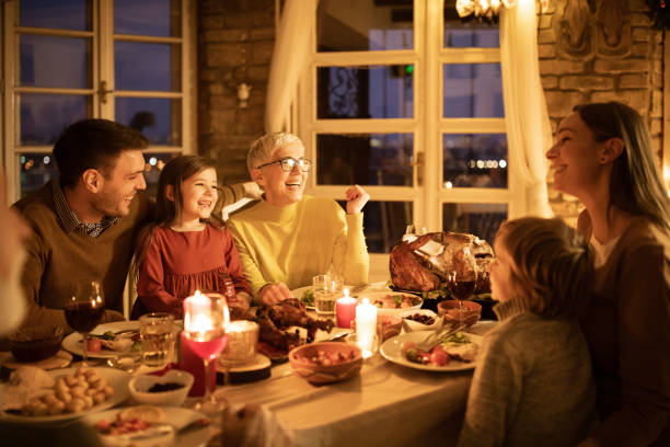 istock Cheerful multi-generation family talking during Thanksgiving dinner at home. 1411355373