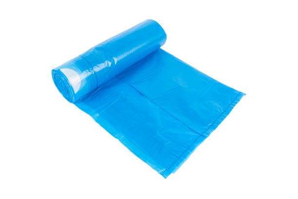 istock Blue rolls of garbage bin bags isolated on white background with copy space. Roll of garbage bags close-up 1411355478