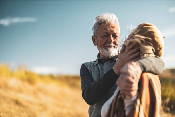 istock Affectionate senior man talking to his wife in autumn day. 1411355703