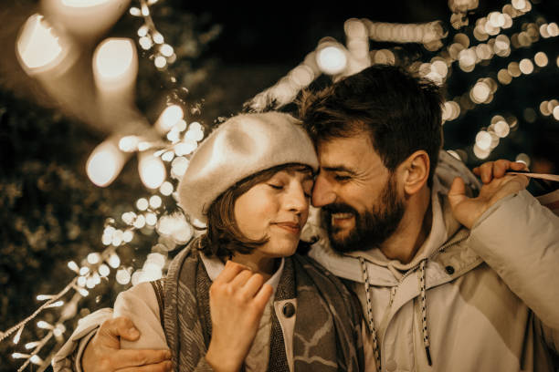 love is in the christmas air - city night lighting equipment mid air imagens e fotografias de stock