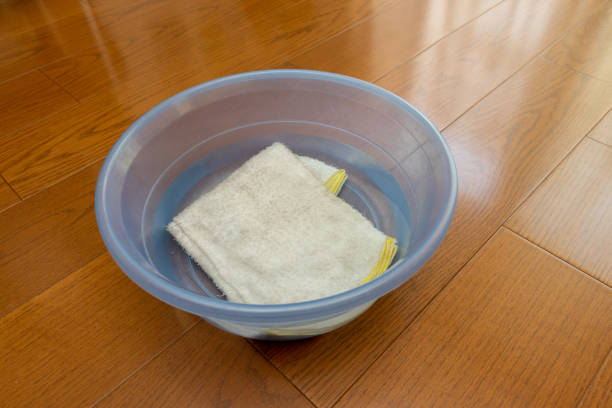 Cleaning cloth soaked in water in a basin