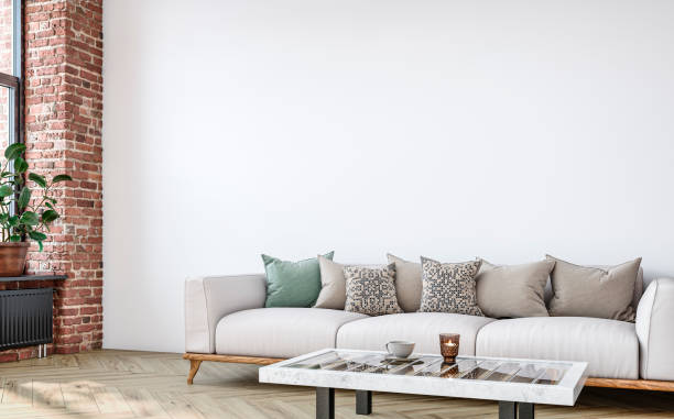 istock Empty nostalgic retro living room with beige sofa,  colored cushions, coffee table, and decoration (potted plant) in front of a colored wall and partly ruined brick wall 1411362058