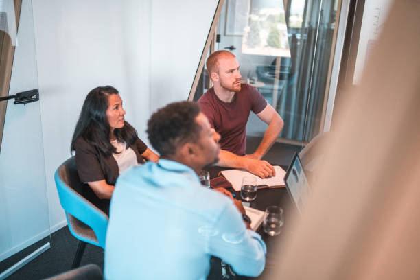 istock High angle View of Small Group of Multiracial Colleagues Seated at Table 1411362455