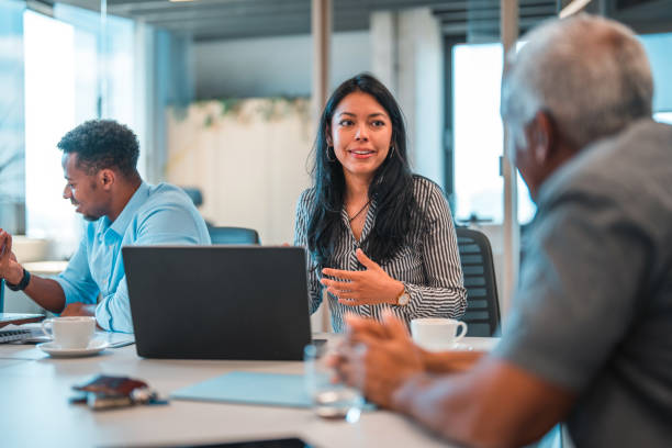 istock Latin Female Manager Explaining Tasks to Mature man 1411362690