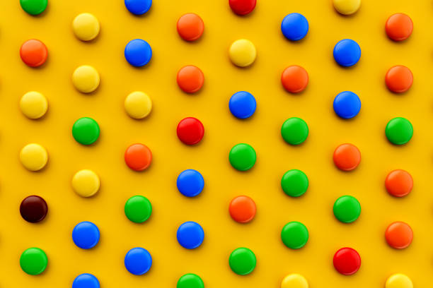 istock Colorful candy pattern on a yellow background viewed from above. Sweet bonbons isolated on a yellow background. Top view 3d illustration 1411363929