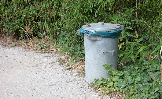 Big metal bin in nature, collecting rubbish