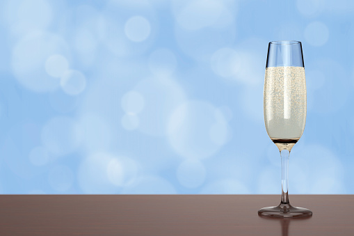Champagne Flute Glass with Bubbles on a blue background. 3d Rendering