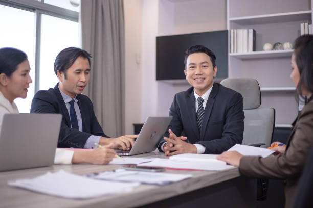 istock Concentrated multiethnic coworker busy using laptop brainstorm sharing thoughts at office meeting 1411366786