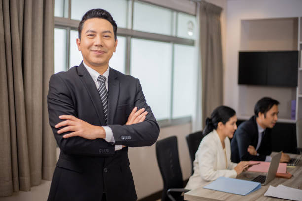 istock Asian business people and partners discussing documents and ideas at meeting 1411366789