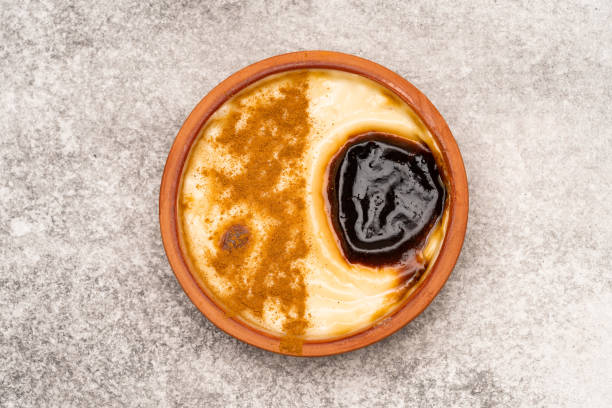 istock Turkish dessert.  Rice pudding with cinnamon on the vintage background 1411366810
