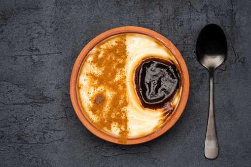 Turkish dessert.  Rice pudding with cinnamon on the black background