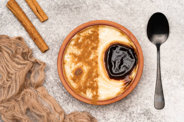 istock Turkish dessert.  Rice pudding with cinnamon on the vintage background 1411366812