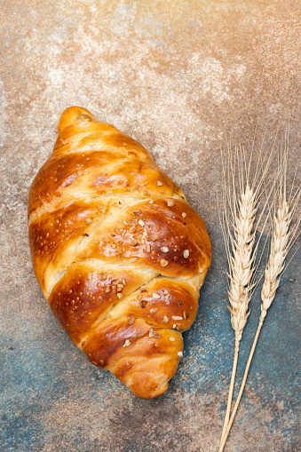 Homemade braided Challah bread on vintage background