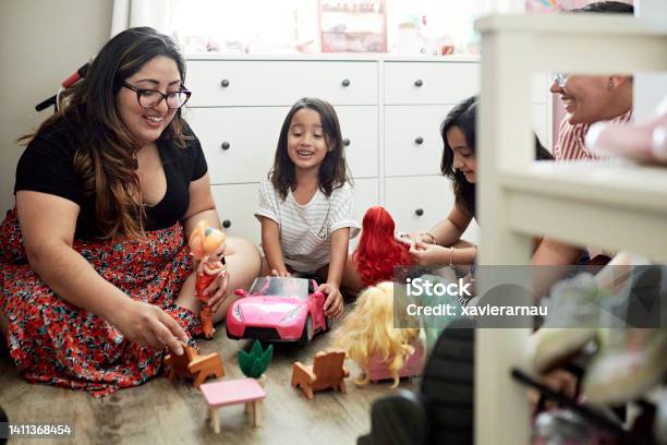 Lesbian Parents And Young Daughters Playing With Dolls Stock Photo - Download Image Now