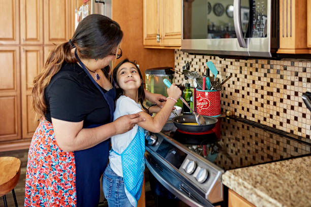 istock Mother and child face to face and smiling while cooking 1411368457